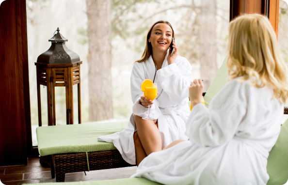 cheerful women in bathrobes drinking juice in spa 2025 02 21 19 41 16 utc