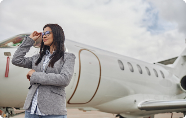happy female business woman near her private jet 2024 10 18 08 08 20 utc
